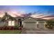 Charming single-story home with a well-manicured lawn, lush landscaping, and a spacious three-car garage at 452 Tierra Verde Way, Bradenton, FL 34212