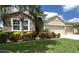 Charming home with beautiful stone accents, lush landscaping, and a well-manicured lawn at 452 Tierra Verde Way, Bradenton, FL 34212