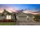 Charming single-story home with a well-manicured lawn, lush landscaping, and a spacious three-car garage at 452 Tierra Verde Way, Bradenton, FL 34212