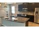Bright kitchen features granite counters, stainless steel appliances, and a center island with a sink at 452 Tierra Verde Way, Bradenton, FL 34212
