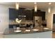 Modern kitchen with granite counters, stainless steel appliances, dark cabinets, and pendant lighting at 452 Tierra Verde Way, Bradenton, FL 34212