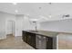 Open kitchen features granite counters, dark cabinets, an island with a sink, and an adjacent living area at 452 Tierra Verde Way, Bradenton, FL 34212
