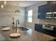 Bright kitchen features granite counters, stainless steel appliances, and a center island with a sink at 452 Tierra Verde Way, Bradenton, FL 34212