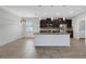 Modern kitchen with granite counters, stainless steel appliances, dark cabinets, and pendant lighting at 452 Tierra Verde Way, Bradenton, FL 34212