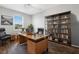 Well-appointed home office with a large desk, bookshelves, and ample natural light at 452 Tierra Verde Way, Bradenton, FL 34212
