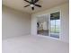 Covered patio with ceiling fan and view of the open sliding door to the kitchen and living area at 452 Tierra Verde Way, Bradenton, FL 34212