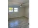 This bedroom has tile floors, a ceiling fan, and a window for natural light at 618 Jungle Queen Way, Longboat Key, FL 34228