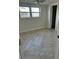 Neutral bedroom features tile floor, new paint, dual pane windows, and standard closet at 618 Jungle Queen Way, Longboat Key, FL 34228