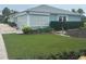 Charming single-story home with a well-manicured lawn and mature landscaping, including hedges and palm trees at 618 Jungle Queen Way, Longboat Key, FL 34228