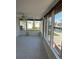 Bright lanai features tile flooring, roll down shades, a ceiling fan and water views at 618 Jungle Queen Way, Longboat Key, FL 34228