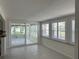 Open-concept room with sliding glass doors to a sunroom and windows with shutters, offering ample natural light at 618 Jungle Queen Way, Longboat Key, FL 34228