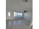 Bright living room features new neutral paint, ample natural light from large windows, and stylish tile floors at 618 Jungle Queen Way, Longboat Key, FL 34228