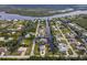 Aerial view of a waterfront home with a screened in pool that has direct canal access at 9008 Allapata Ln, Venice, FL 34293