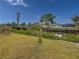 The backyard view has a canal, lush greenery, and serene waters, for outdoor enjoyment at 9008 Allapata Ln, Venice, FL 34293