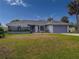 Charming single-story home with a well-maintained lawn, lush landscaping, and a two-car garage at 9008 Allapata Ln, Venice, FL 34293