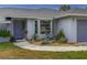 Well-maintained front yard with lush xeriscaping featuring native plants and walkway leading to the entrance at 9008 Allapata Ln, Venice, FL 34293
