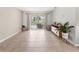 Bright living room with tile floors and sliding glass doors offering views of the screened in pool at 9008 Allapata Ln, Venice, FL 34293