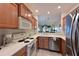 Efficient kitchen layout featuring stainless steel appliances and pass-through to living area at 1003 Fairwaycove Ln # 101, Bradenton, FL 34212