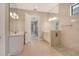 Bright bathroom boasts dual vanities, a walk-in shower and neutral tile flooring at 10612 Nicklaus Ct, Englewood, FL 34223