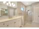 Bright bathroom featuring stone countertops, modern fixtures, and large tiled shower with pebble flooring at 10612 Nicklaus Ct, Englewood, FL 34223