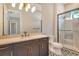 This bathroom features a dual sink vanity, shower and unique patterned floor at 10612 Nicklaus Ct, Englewood, FL 34223