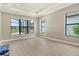 Bedroom featuring neutral walls and tile flooring showcases natural light with views of the golf course at 10612 Nicklaus Ct, Englewood, FL 34223