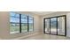 Bedroom with neutral walls, tile floors, large window, and glass doors overlooking pool and golf course at 10612 Nicklaus Ct, Englewood, FL 34223