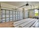 Spacious garage with multiple bays and ample storage space presents opportunity for easy organization at 10612 Nicklaus Ct, Englewood, FL 34223