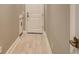 Hallway with tile floor, utility sink and white door at 10612 Nicklaus Ct, Englewood, FL 34223