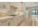 Gourmet kitchen features a gas range, quartz countertops, and custom drawers at 10612 Nicklaus Ct, Englewood, FL 34223