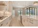 Spacious kitchen with a large island, stainless appliances, and a view of the outdoor living area at 10612 Nicklaus Ct, Englewood, FL 34223