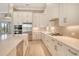 Gourmet kitchen features stainless appliances, a gas range, and a large island at 10612 Nicklaus Ct, Englewood, FL 34223