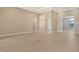Spacious living room boasts tile floors, neutral walls, recessed lighting and open doorway to the entryway at 10612 Nicklaus Ct, Englewood, FL 34223