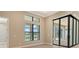 Sun-filled living room has multiple windows and sliding glass doors at 10612 Nicklaus Ct, Englewood, FL 34223