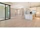 Bright open-plan living area featuring tile floors, modern kitchen with stainless steel appliances and neutral color palette at 10612 Nicklaus Ct, Englewood, FL 34223