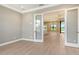 Open concept living area featuring tile floors, and glass doors to backyard at 10612 Nicklaus Ct, Englewood, FL 34223