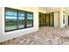 Covered brick patio with walls of windows and sliding glass doors offering great views of the pool at 10612 Nicklaus Ct, Englewood, FL 34223
