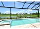 Inviting screened-in pool with a stunning view of the well-maintained golf course at 10612 Nicklaus Ct, Englewood, FL 34223