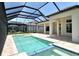 Screened in pool with blue tile accents and outdoor seating area is perfect for entertaining and relaxation at 10612 Nicklaus Ct, Englewood, FL 34223