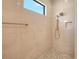 Tiled shower with rainfall shower head and stone flooring at 10612 Nicklaus Ct, Englewood, FL 34223