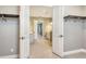 Open walk-in closet leading to luxurious bathroom with dual sinks and stone countertops at 10612 Nicklaus Ct, Englewood, FL 34223