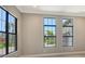 The room has black framed windows providing natural light and outdoor views at 10612 Nicklaus Ct, Englewood, FL 34223
