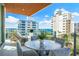 Stylish balcony with comfortable seating and beautiful water views at 111 Golden Gate Pt # 401, Sarasota, FL 34236