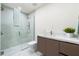 Modern bathroom featuring glass shower, white marble floors and countertops, and a stylish brown cabinet at 111 Golden Gate Pt # 401, Sarasota, FL 34236