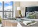 Inviting bedroom featuring city views, stylish bedside decor, and comfortable bedding at 111 Golden Gate Pt # 401, Sarasota, FL 34236
