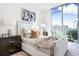 Comfortable bedroom with a plush bed, modern nightstands, and beautiful city views from large windows at 111 Golden Gate Pt # 401, Sarasota, FL 34236