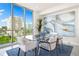 Bright dining area with a glass table, stylish chairs, and a large window with city views at 111 Golden Gate Pt # 401, Sarasota, FL 34236