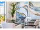 Bright dining area with a glass table, modern chairs, and stylish decor with large windows at 111 Golden Gate Pt # 401, Sarasota, FL 34236