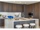 Modern kitchen featuring dark wood cabinets, a white island, and stainless steel appliances at 111 Golden Gate Pt # 401, Sarasota, FL 34236