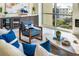 Cozy living room with modern furniture, accent pillows, and a serene view from the large window at 111 Golden Gate Pt # 401, Sarasota, FL 34236